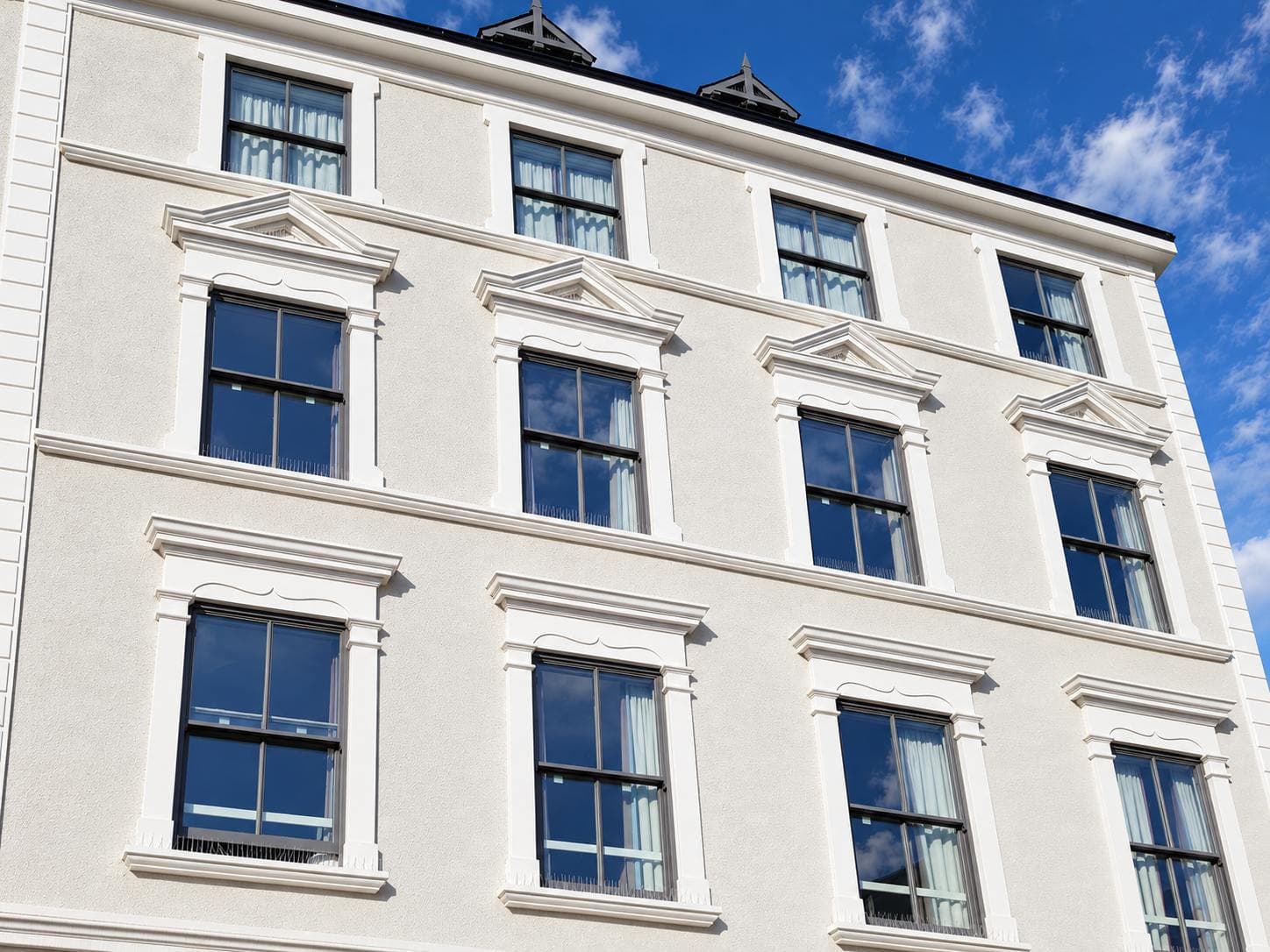 Window pediments and corner pilasters
