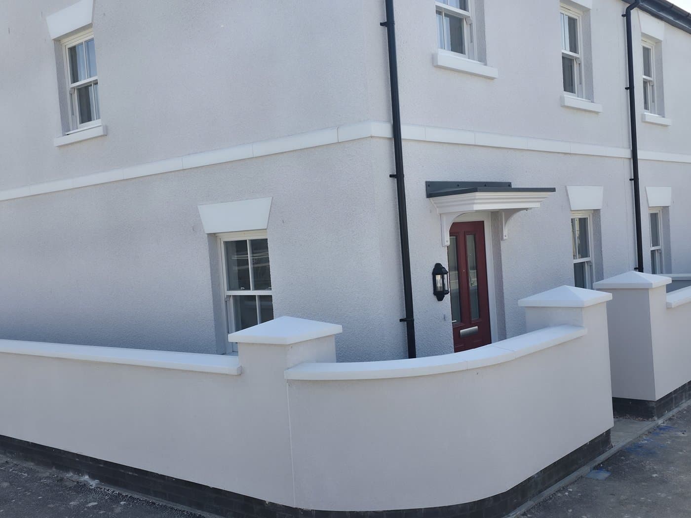 Curved garden wall coping manufactured to a radius, installed on a residential development