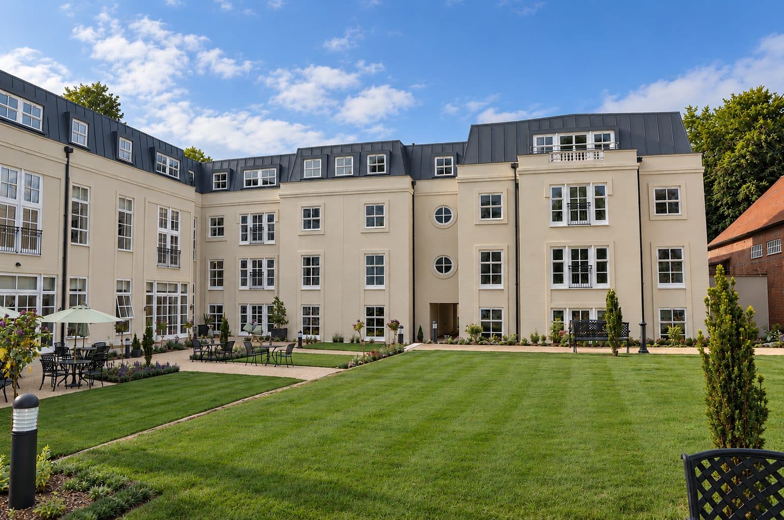 Cream rendered apartment building around a landscaped courtyard