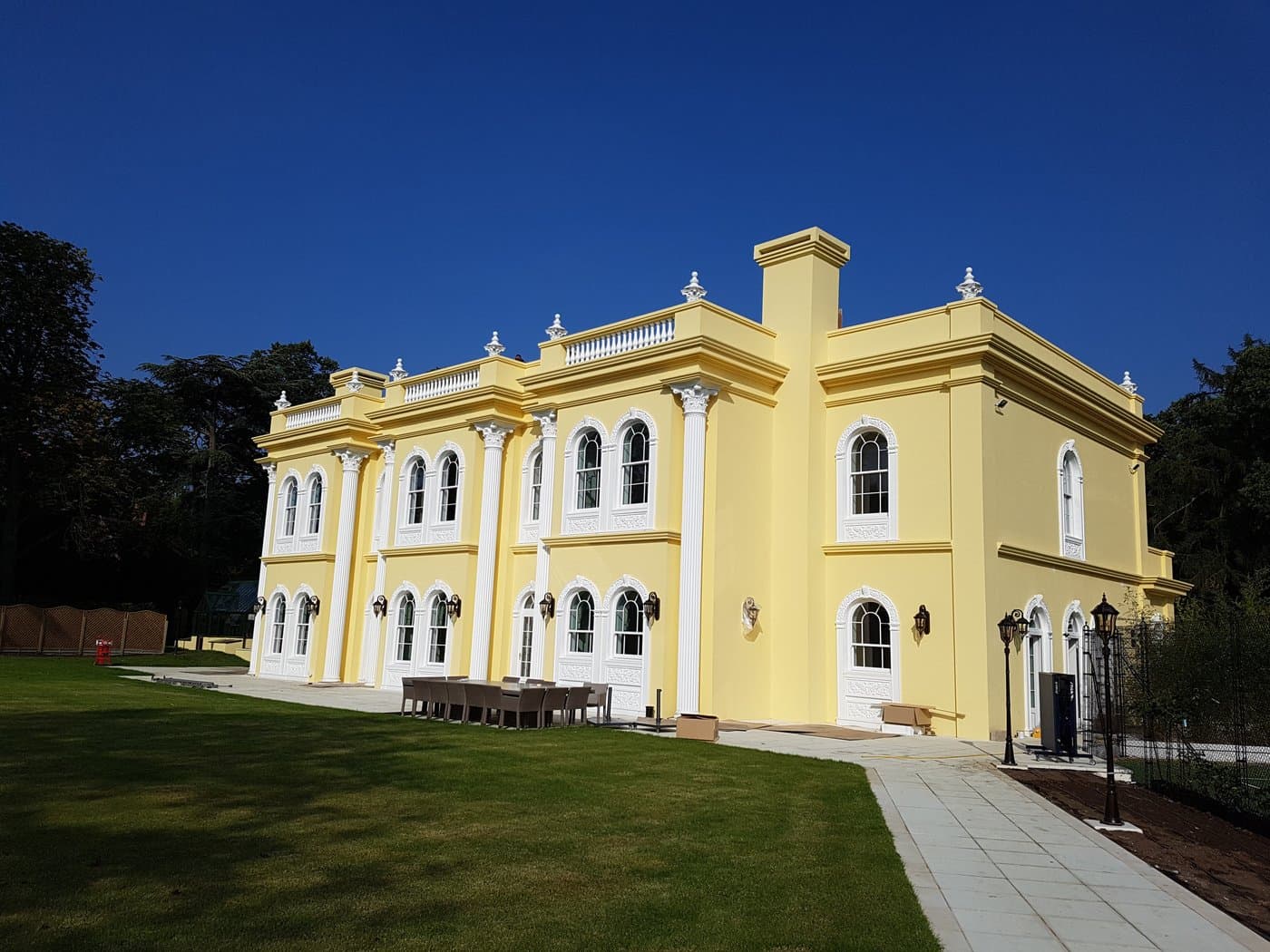 Wide view of the column-and-cornice facade and roofline balustrades.