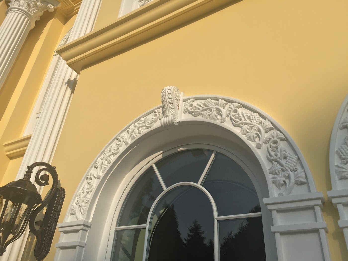 Decorative arched window surround and keystone detail at the Surrey private residence.
