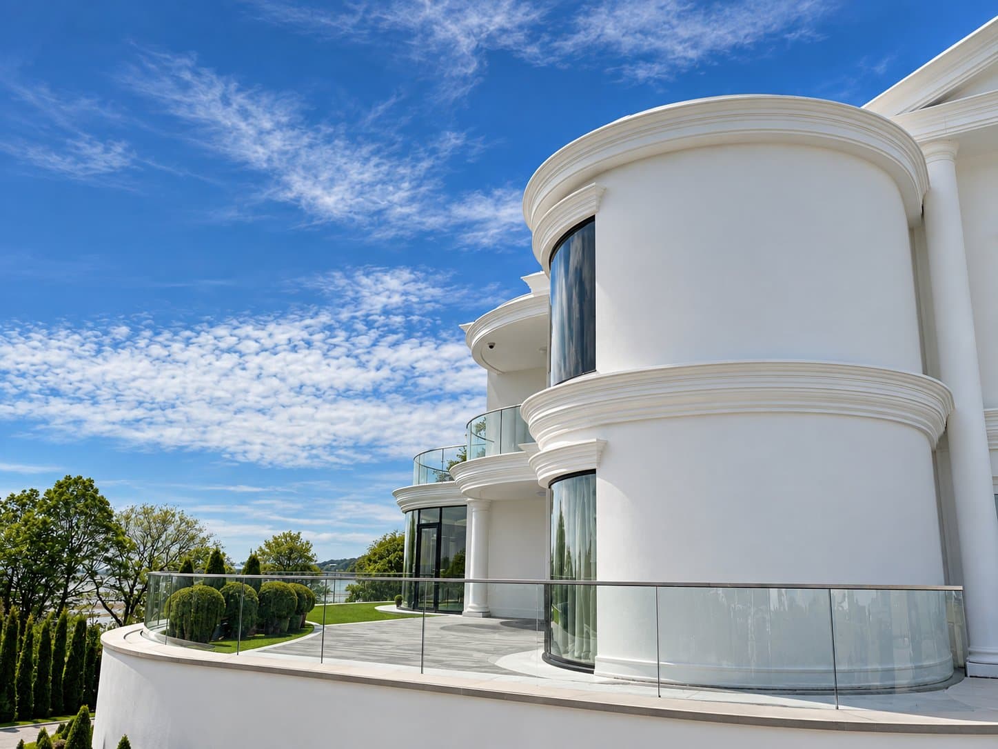 Curved drum tower with a curved eaves cornice, curved string band and a curved window head over curved glazing.